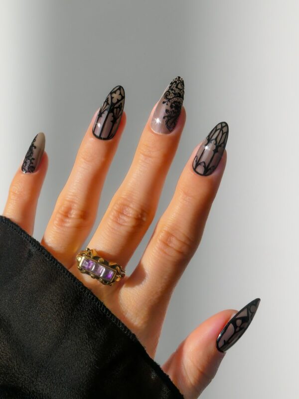 Gothic inspired black nails for Halloween with lace and stained glass designs