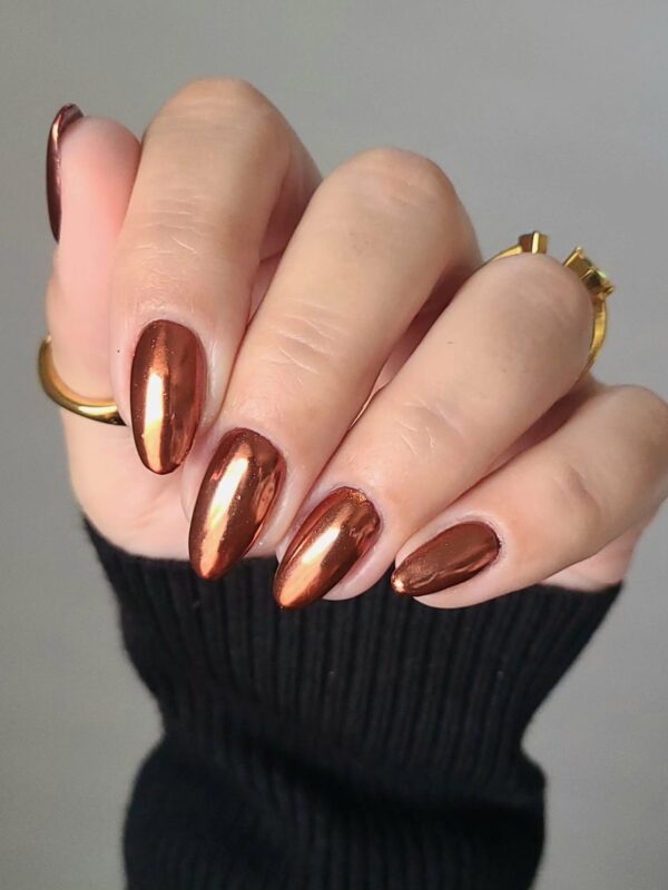 Copper dipped nails in a chrome finish on medium almond tips