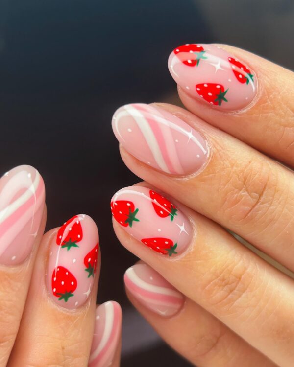 Minimal strawberry nail art with pink swirls and small strawberry accents
