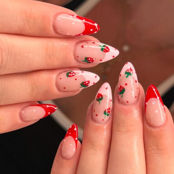 Strawberry french nail tips with polka dots on almond nails