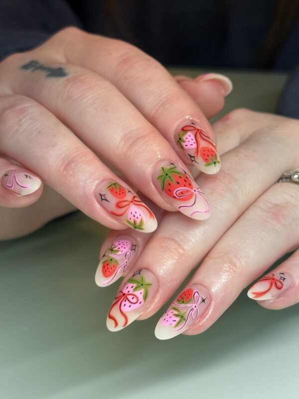 Long almond nails with pink and red strawberries and bows